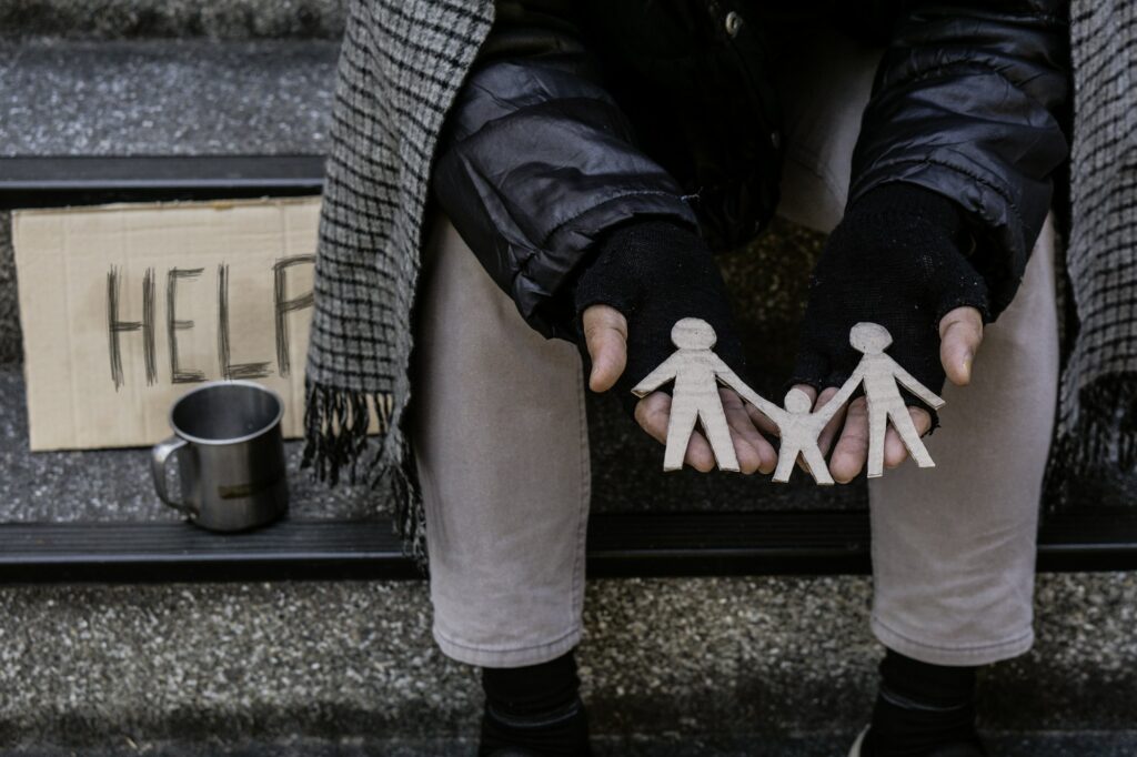 Beggar,Hand of Homeless adult man seeking help for his family on stairs.